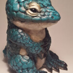 Carisa Swenson, “Little Critters, Big Problems (Endangered Species Chibi) - Abronia”, Magic Sculpt, glass eyes, acrylic paints, wood, 5 inches high x 4 inches wide, $285 (Price for Set $950)
