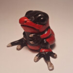 Carisa Swenson, “Little Critters, Big Problems (Endangered Species Chibi) - "Lehman's Poison Frog”, Magic Sculpt, glass eyes, acrylic paints, wood, 1 1/2 inches high x 2 1/2 inches wide, $50 (Price for Set $950)