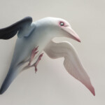 Erika Sanada, “Cursed Raven”, ceramic with cold finish, 12 x 17 x 8 inches, $2,200 | Mythological Inspiration: The white raven from Coronis's Greek mythology